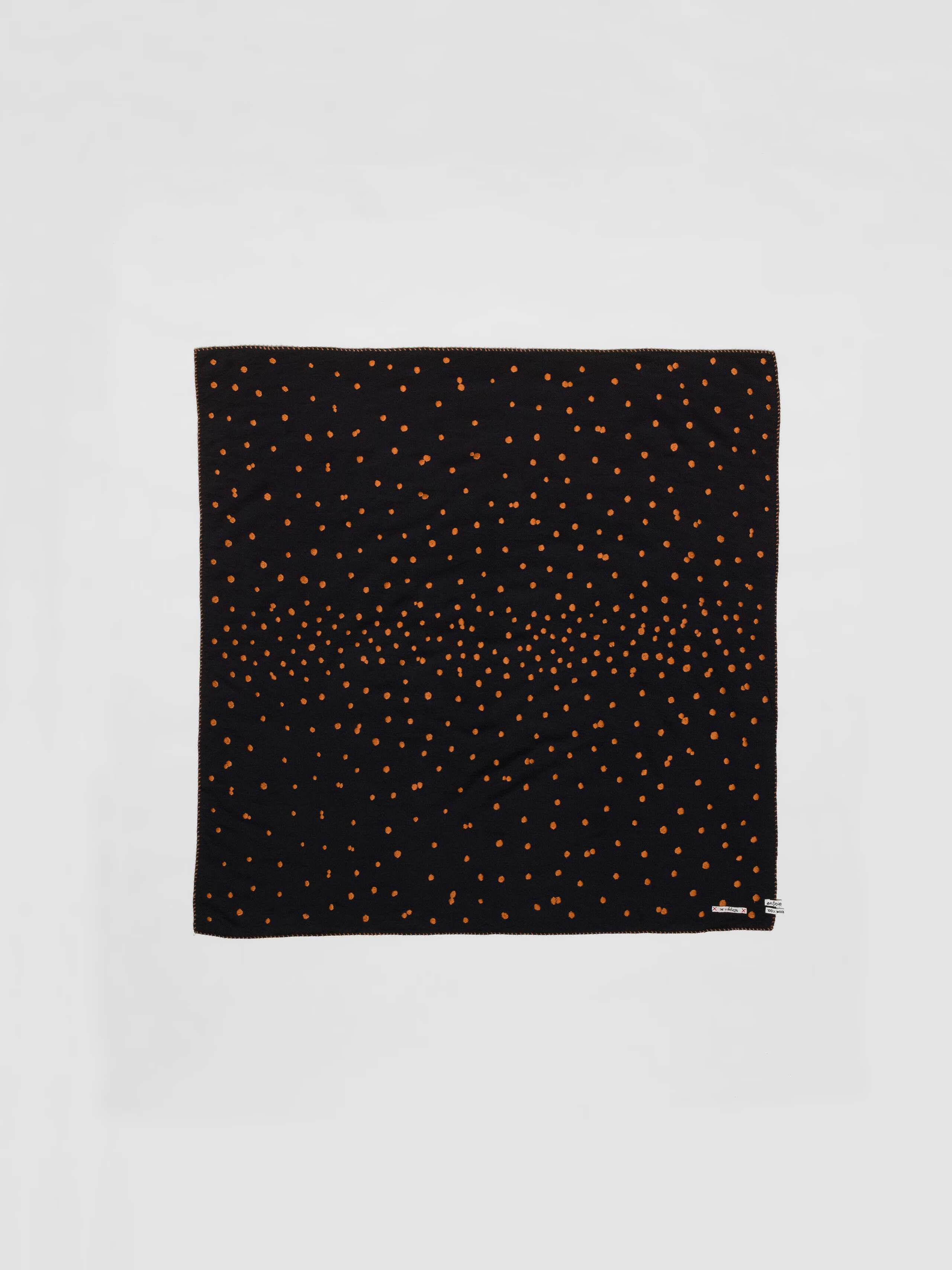 Picture of a wool foulard in black featuring brown hand embroidered dots