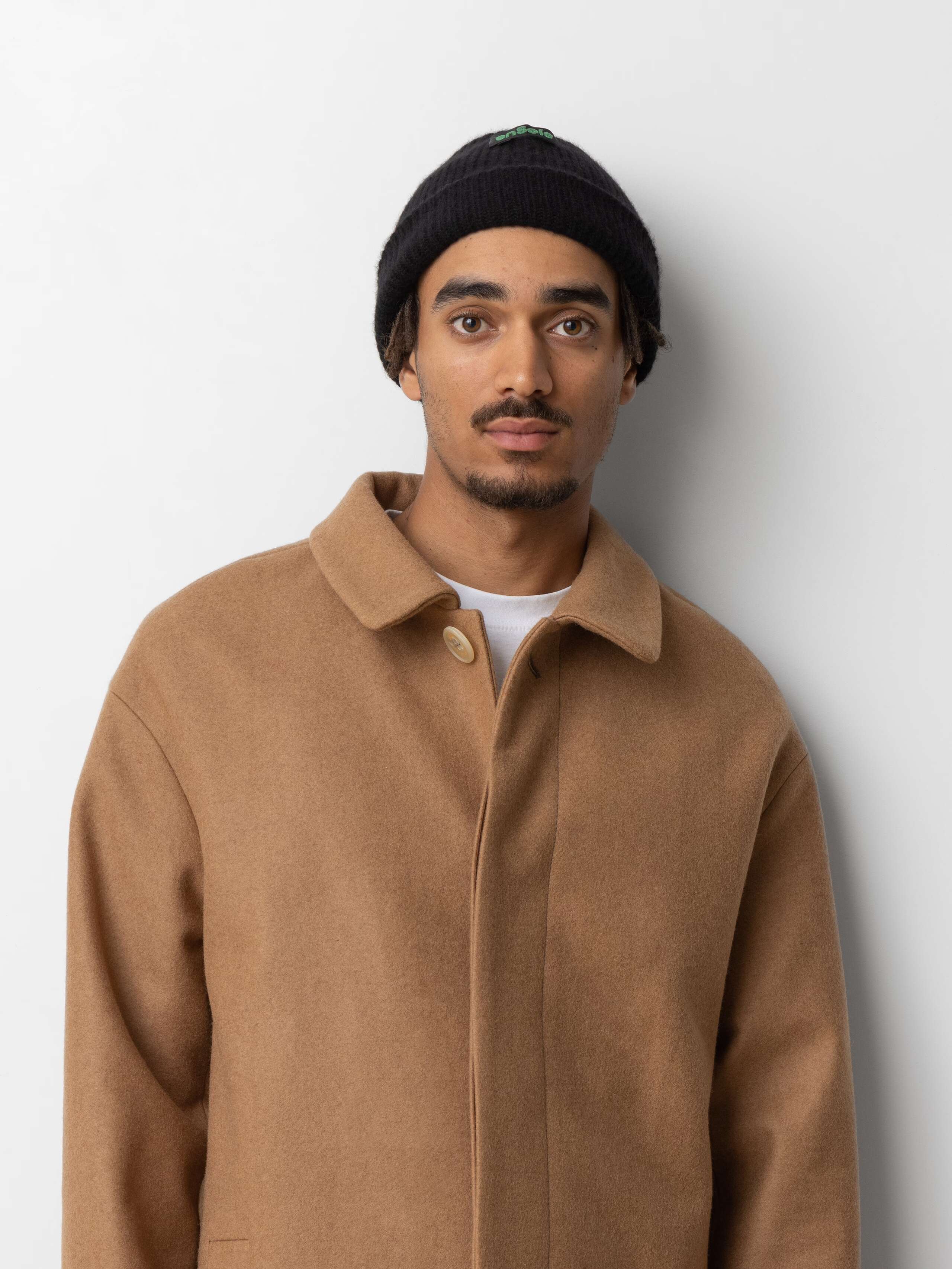 Picture of a male model wearing a black cashmere wool beanie