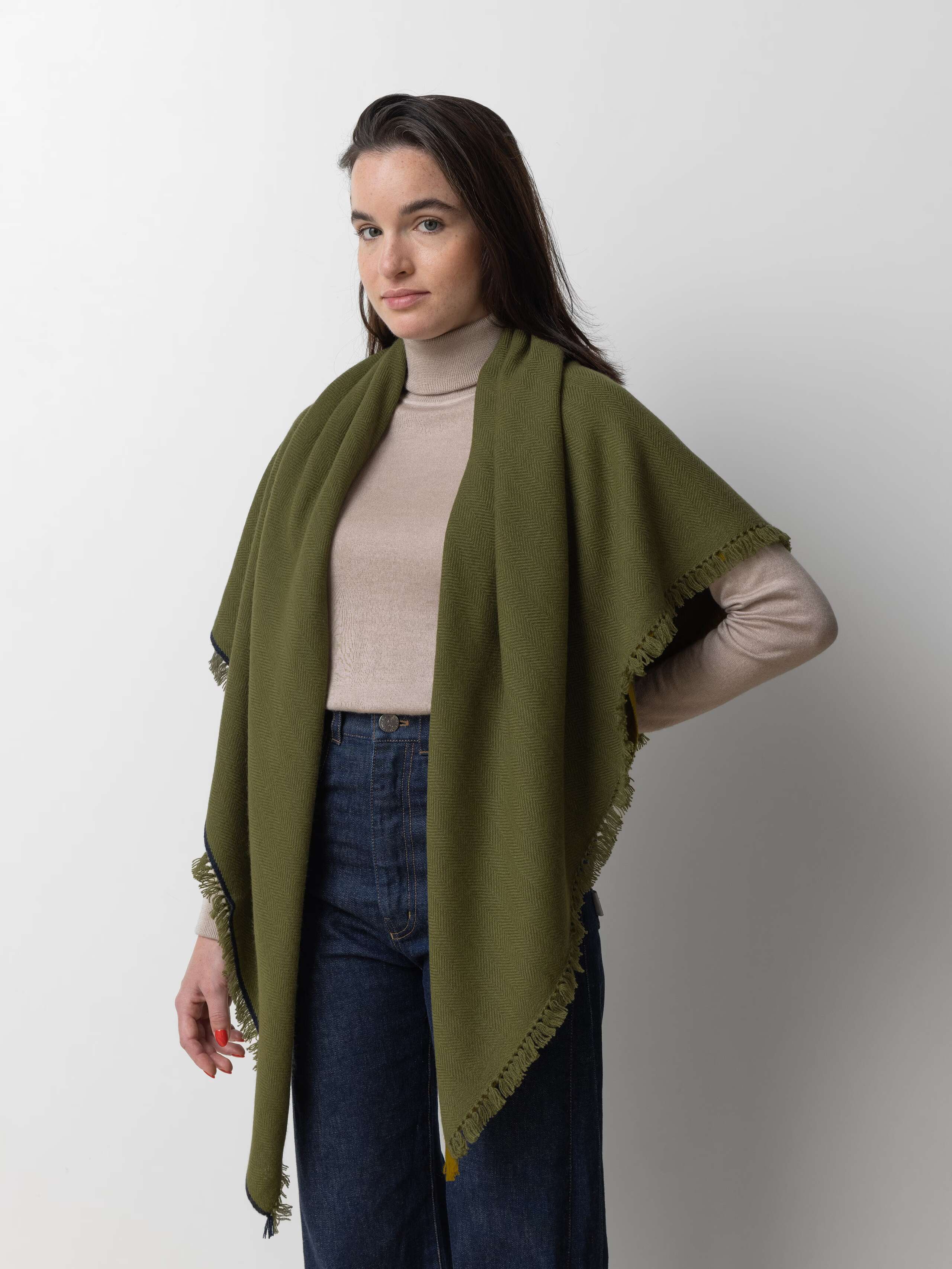 Picture of a female model wearing a warm green cashmere stole