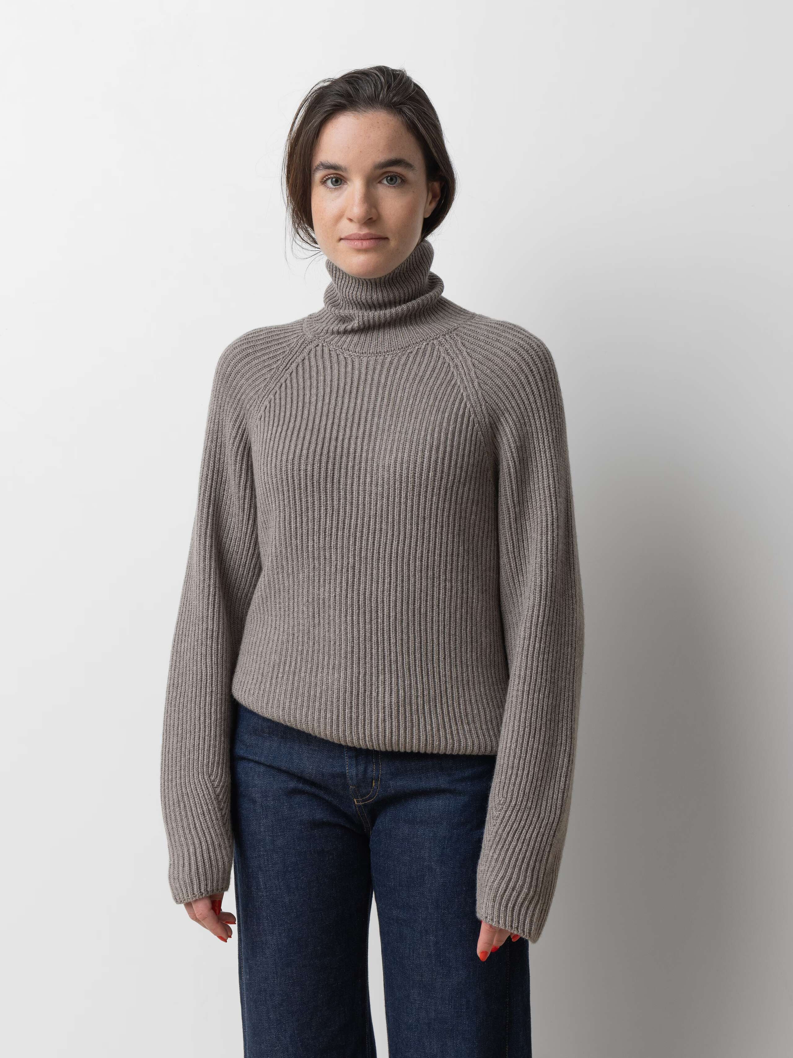 Picture of a female model wearing a beautiful brown grey merino wool sweater 