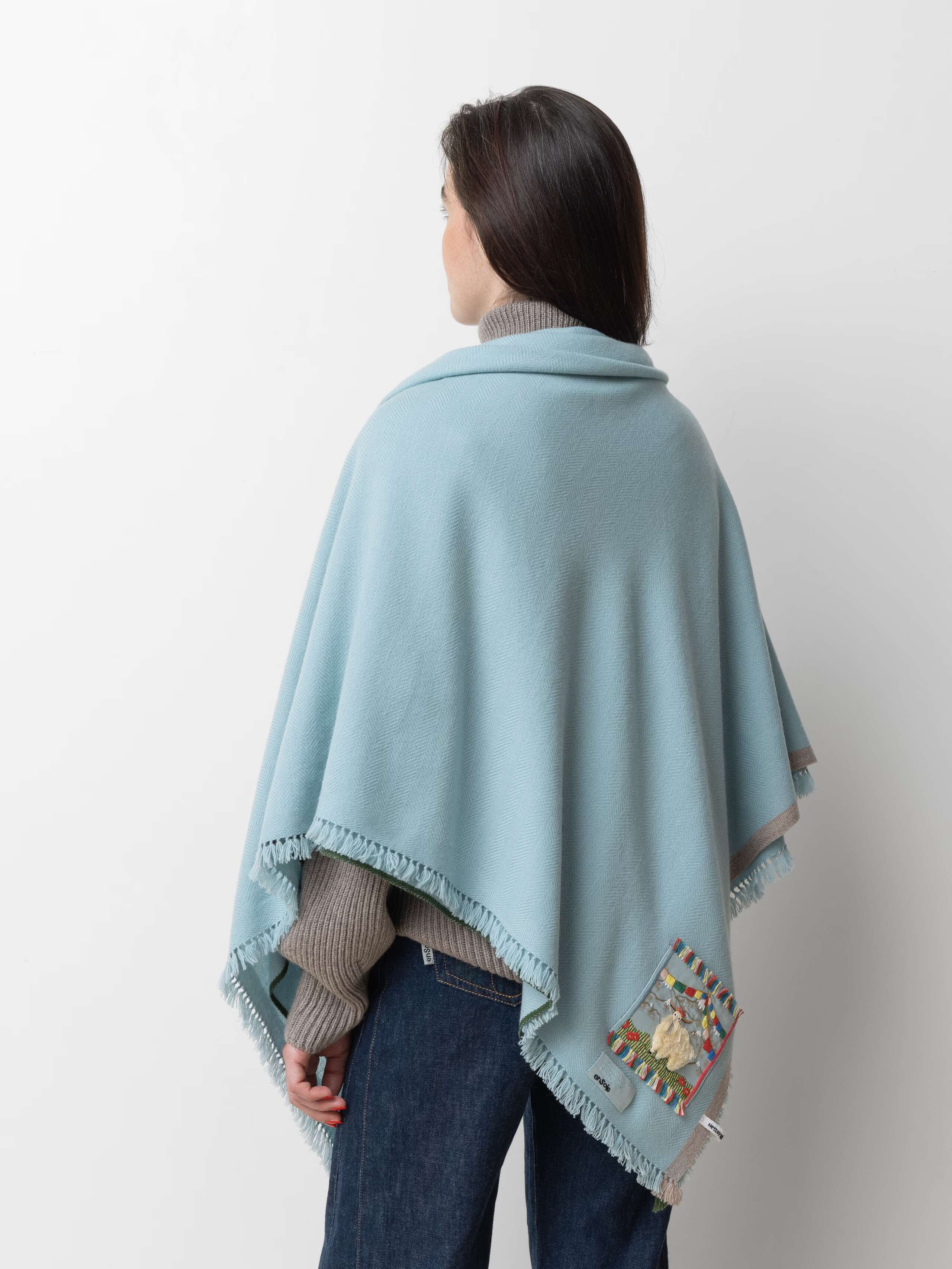 Picture of a female model wearing a sky blue cashmere stole