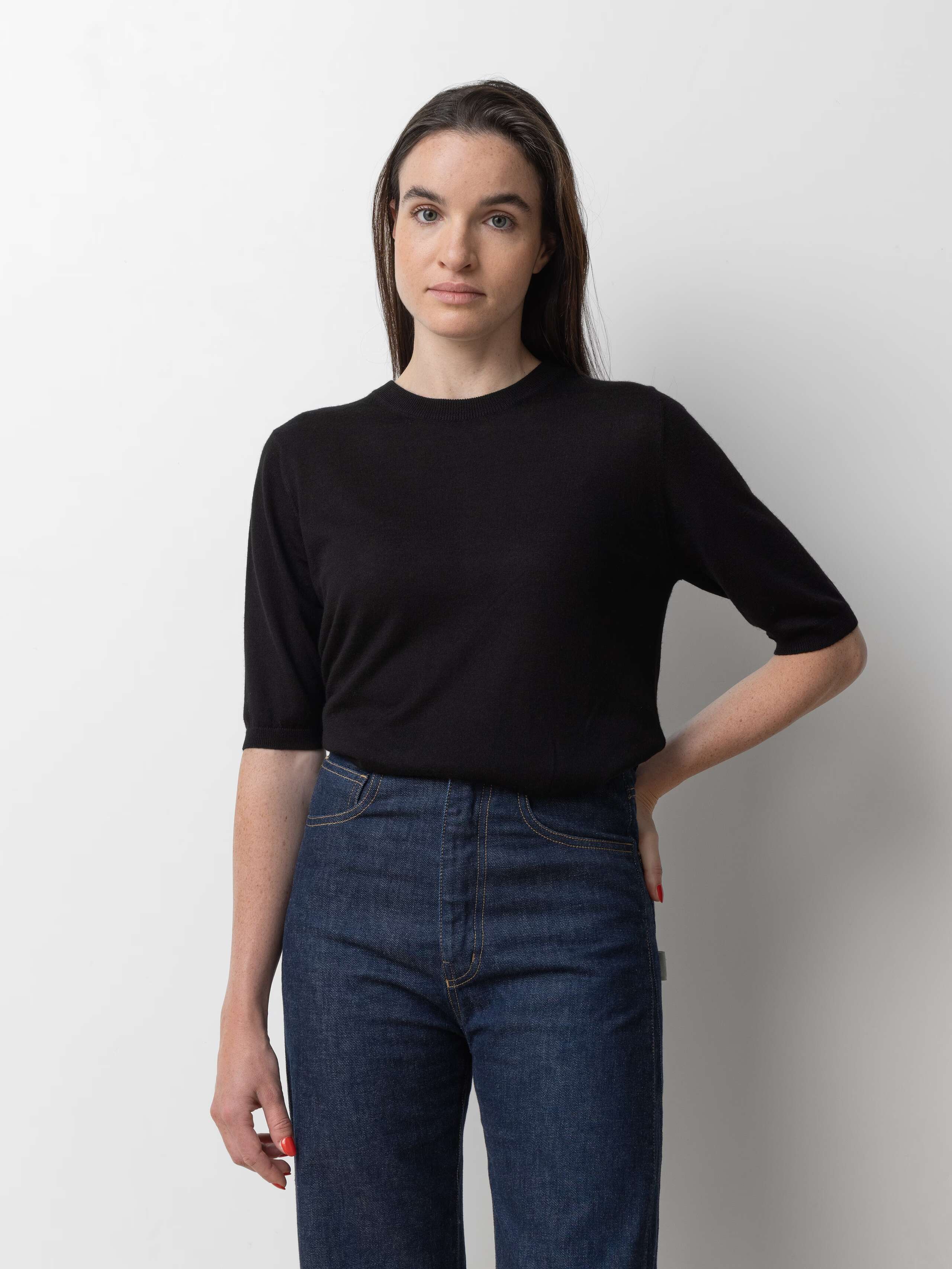Picture of a female model wearing a black cashmere shirt