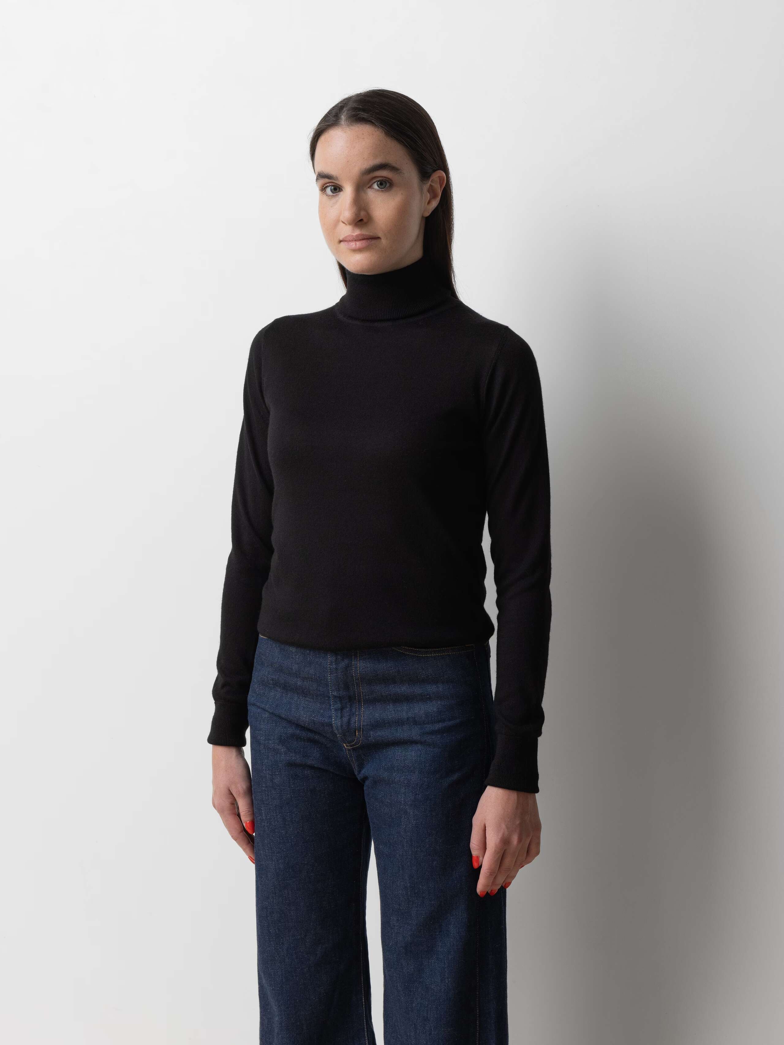 Picture of a female model wearing a black cashmere turtleneck