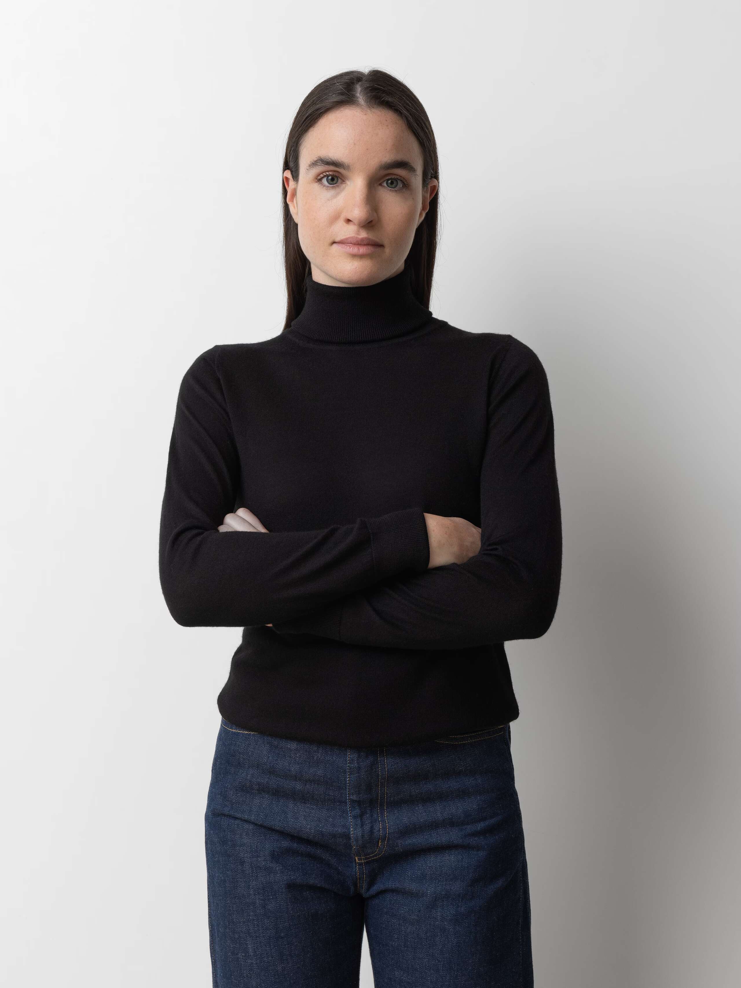 Picture of a female model wearing a black cashmere turtleneck