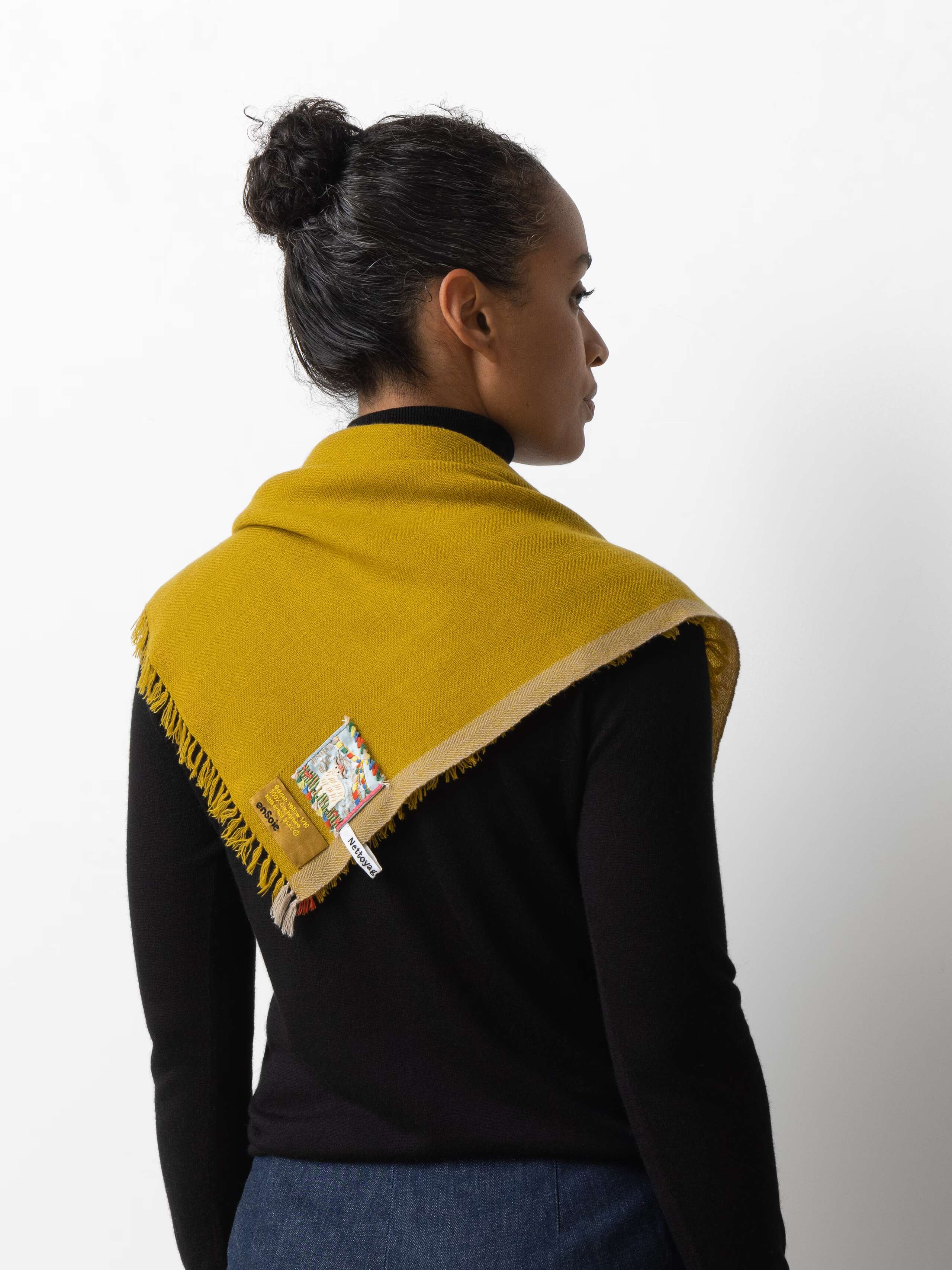 Model wearing Blia mini Cashmere stole in a golden yellow