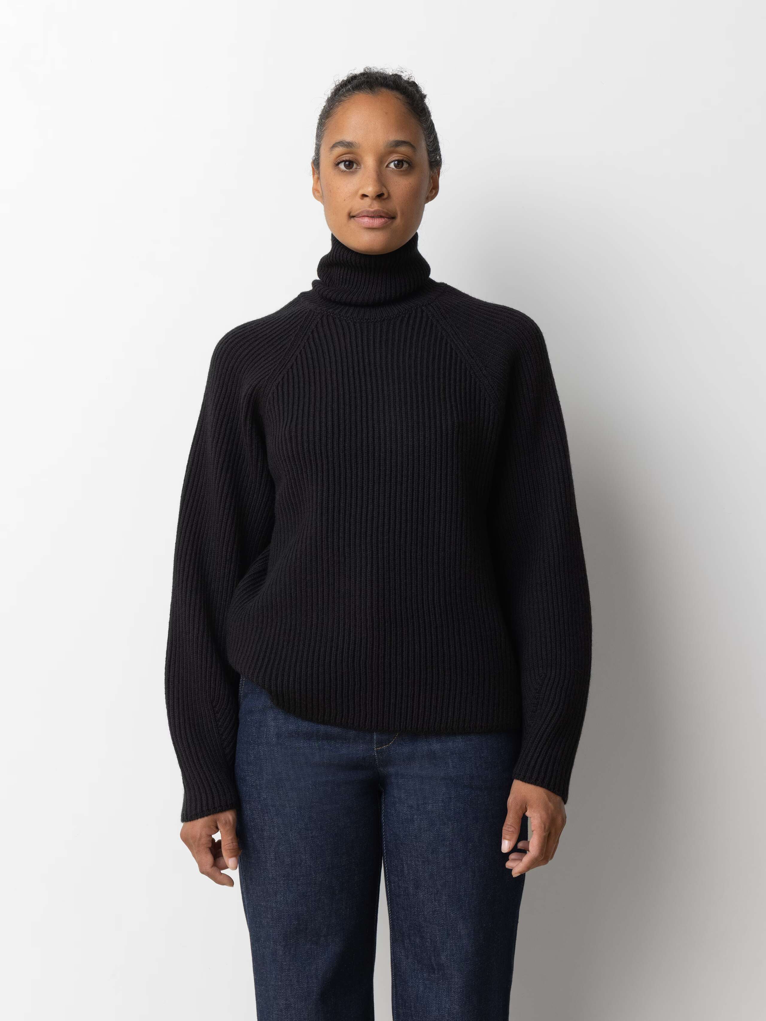 Picture of a female model wearing a beautiful black merino wool sweater 