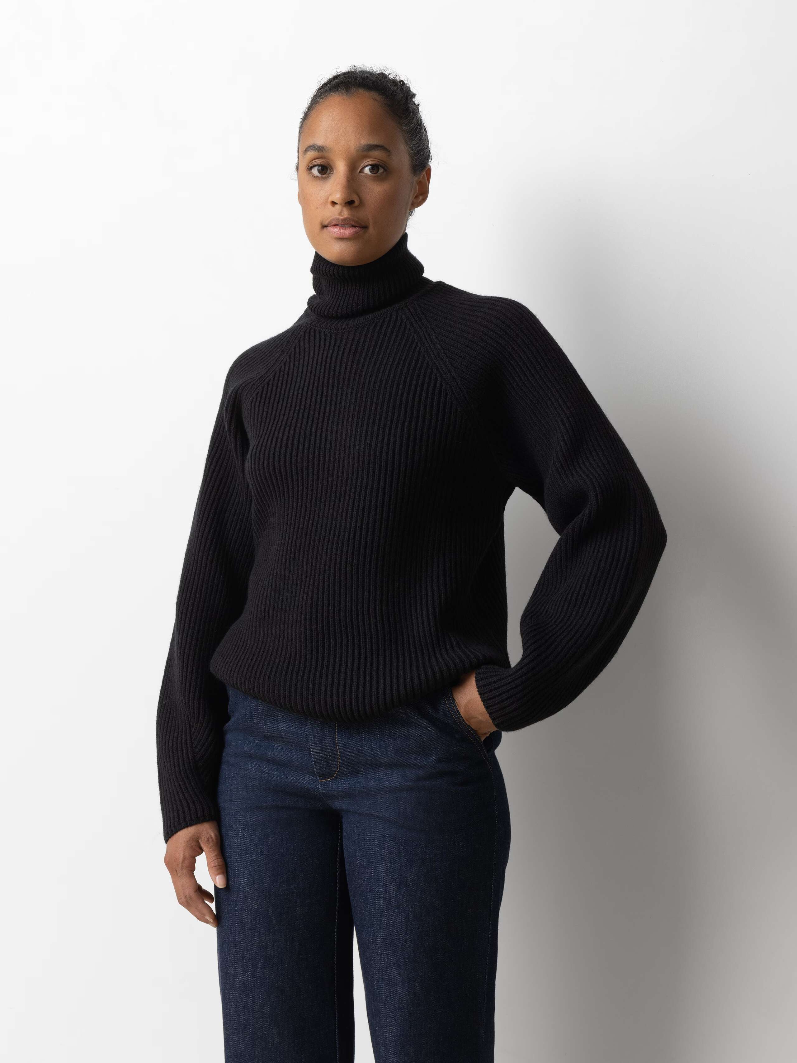 Picture of a female model wearing a beautiful black merino wool sweater 
