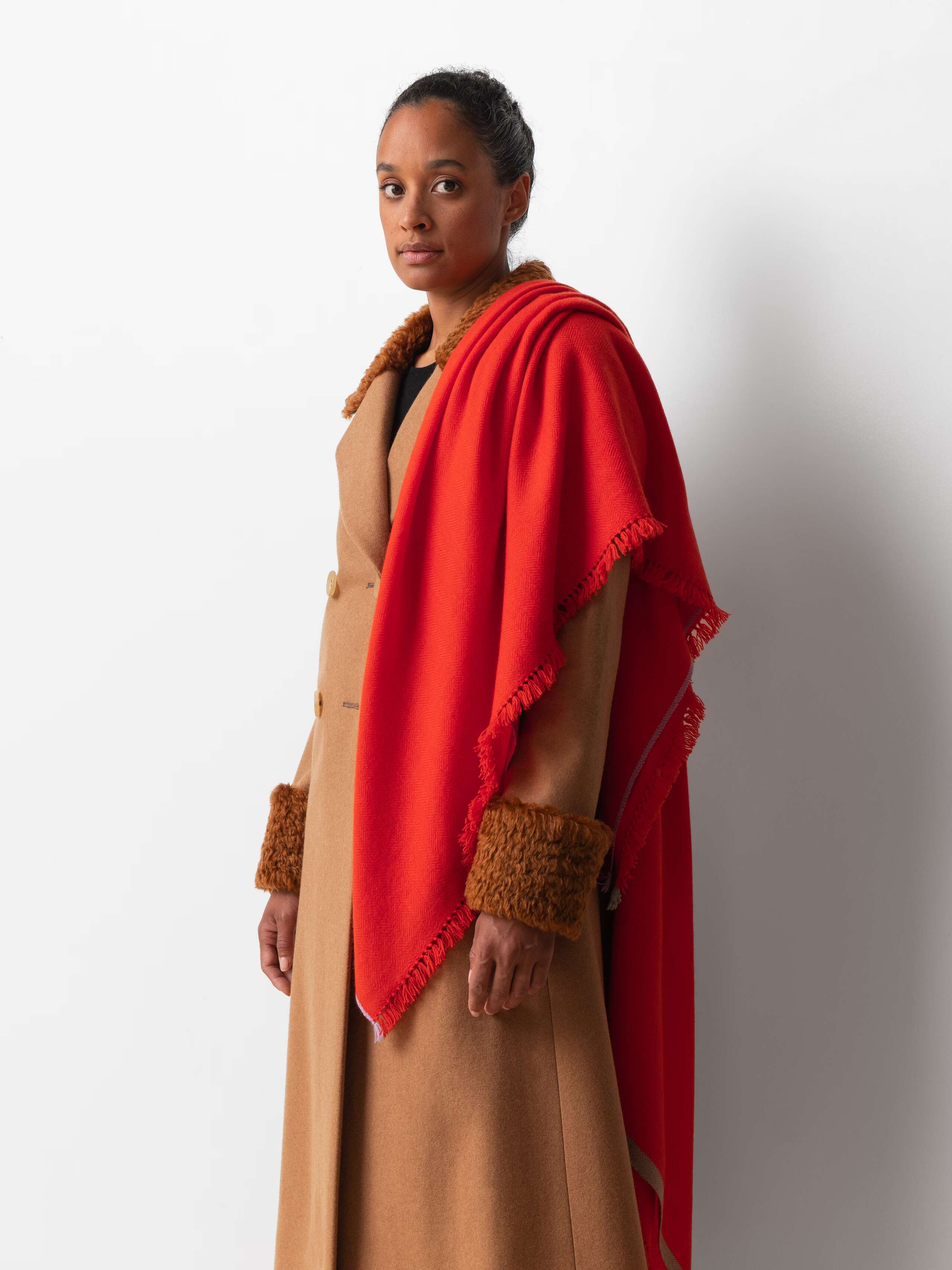 Picture of a female model wearing a bright red cashmere scarf