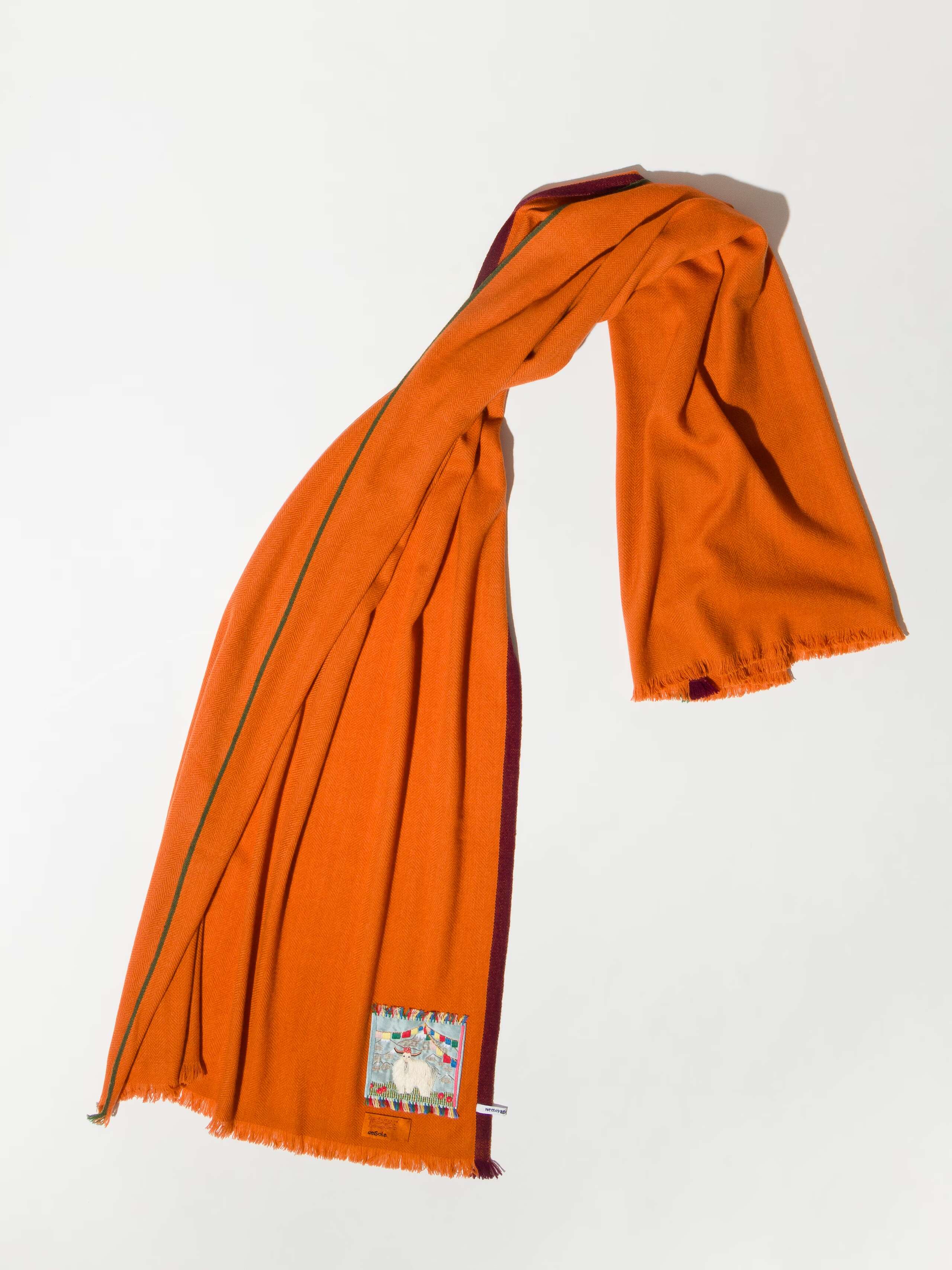 Picture of a long cashmere scarf in warm orange 