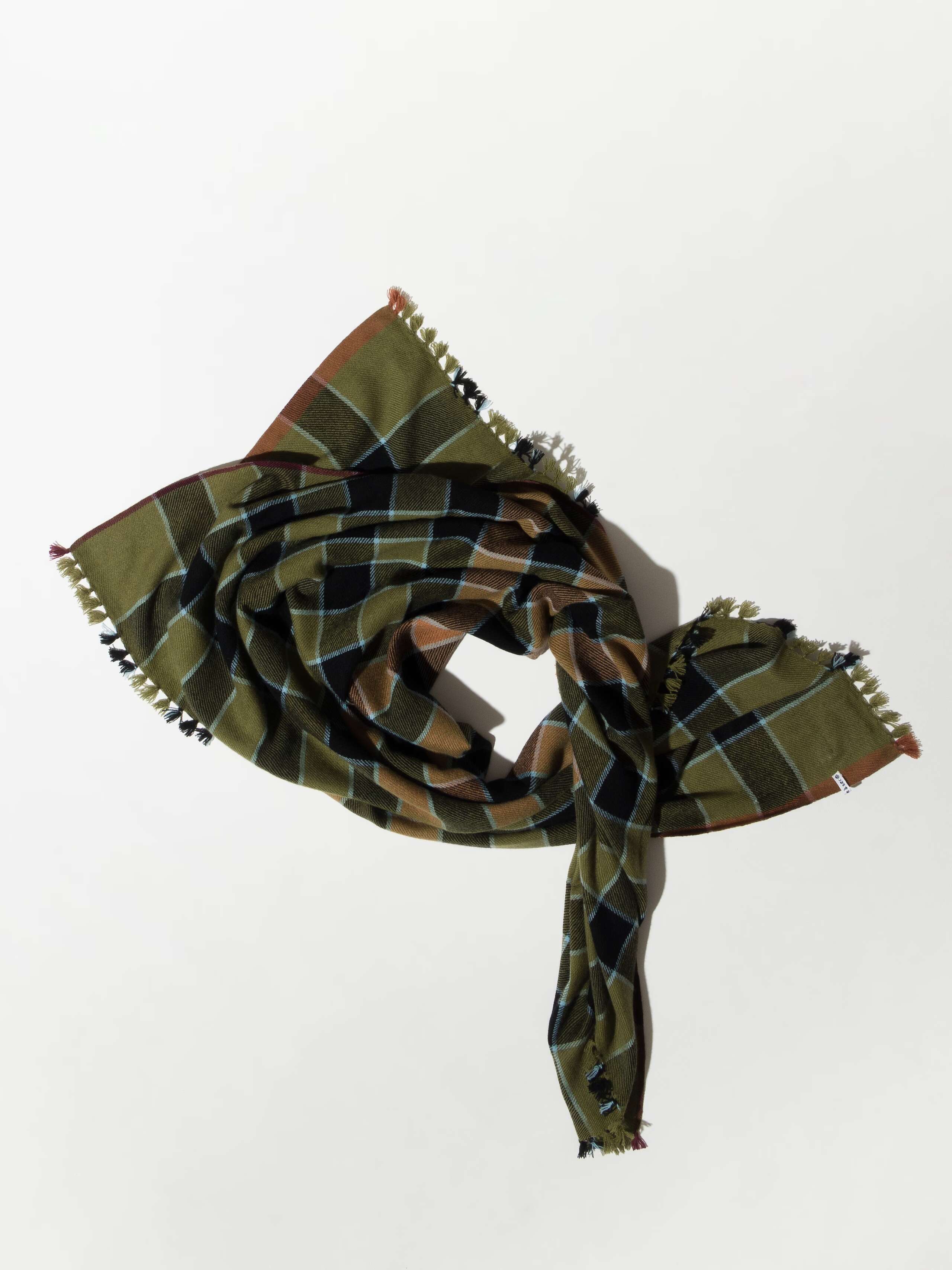 Picture of a checkered wool scarf in beautiful green, red and beige shades