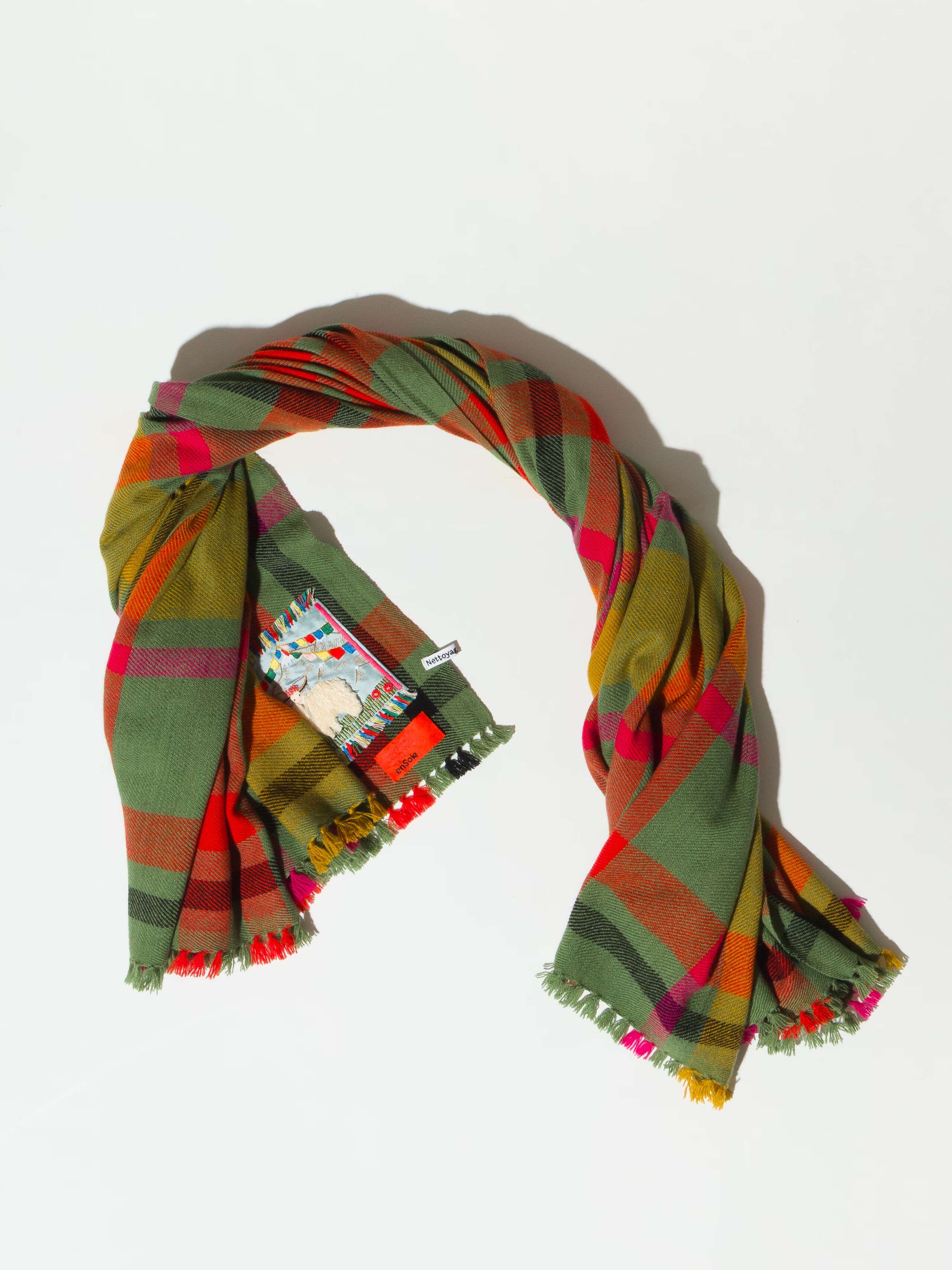 Picture of a checkered wool scarf in beautiful green, red and yellow shades