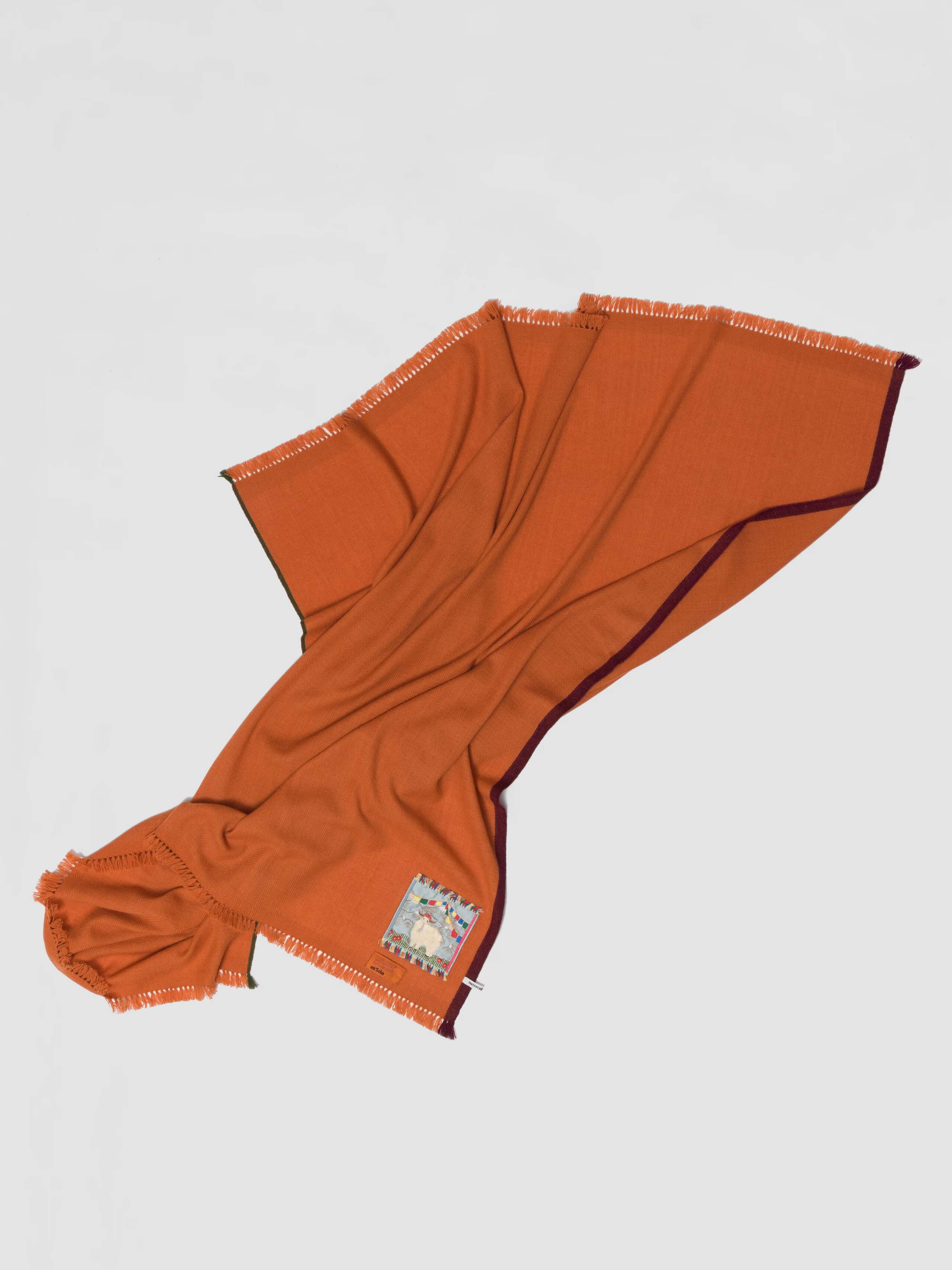 Picture of a detail of an orange cashmere stole