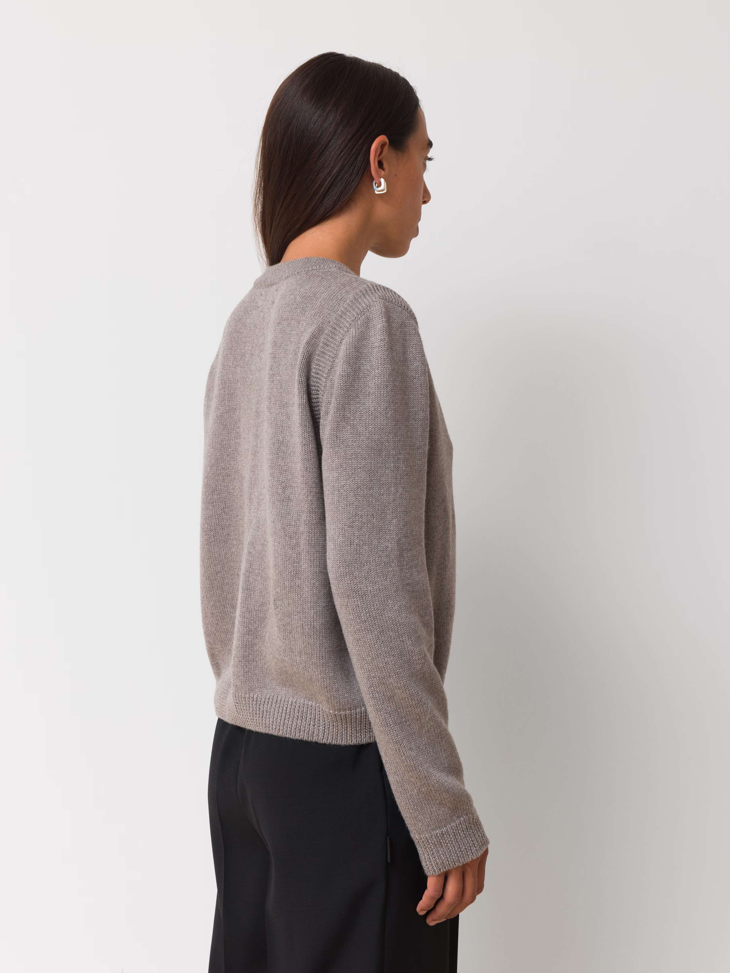 Female model is wearing a beige merino wool cardigan