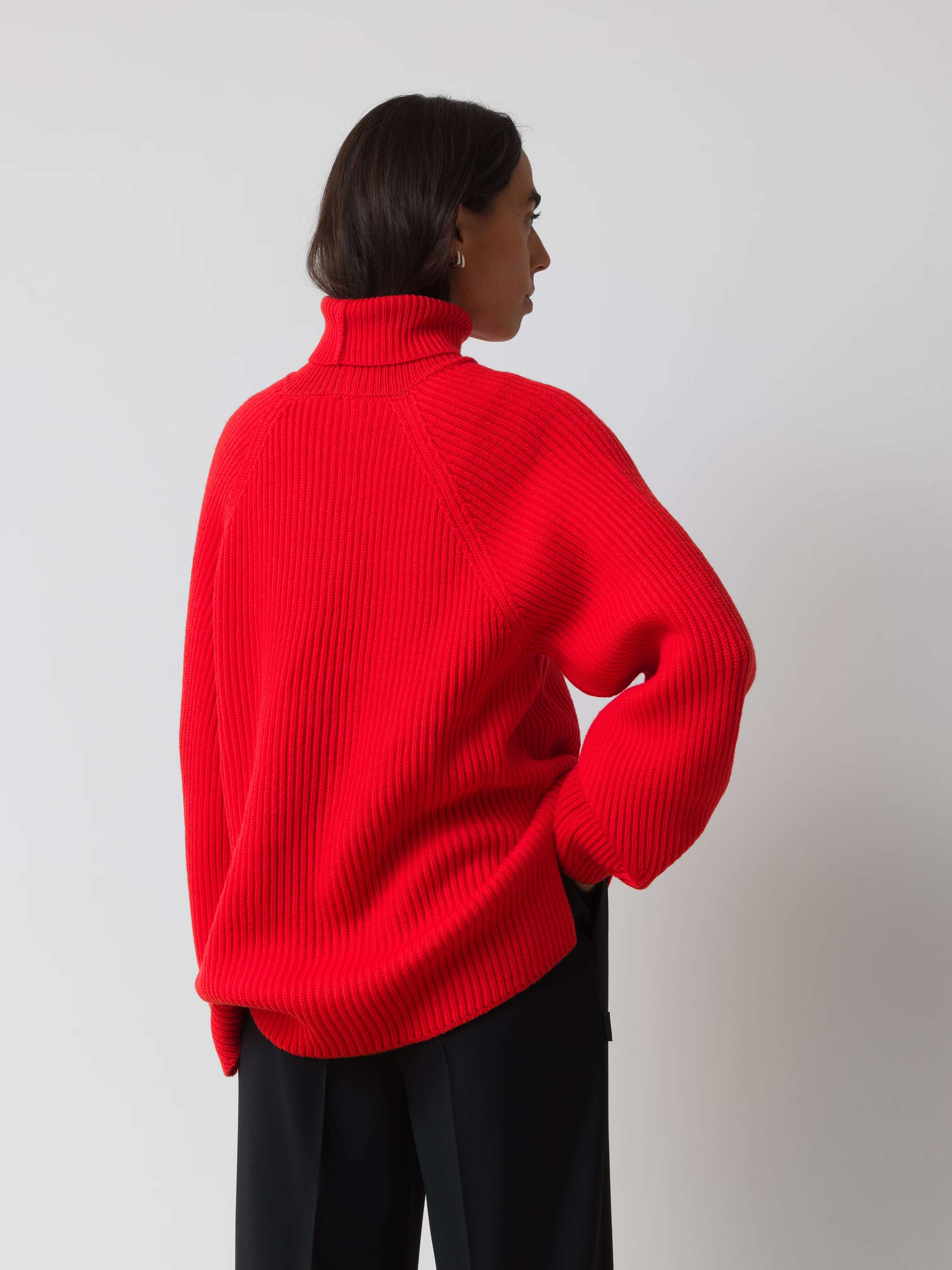Picture of a female model wearing a red turtleneck pullover