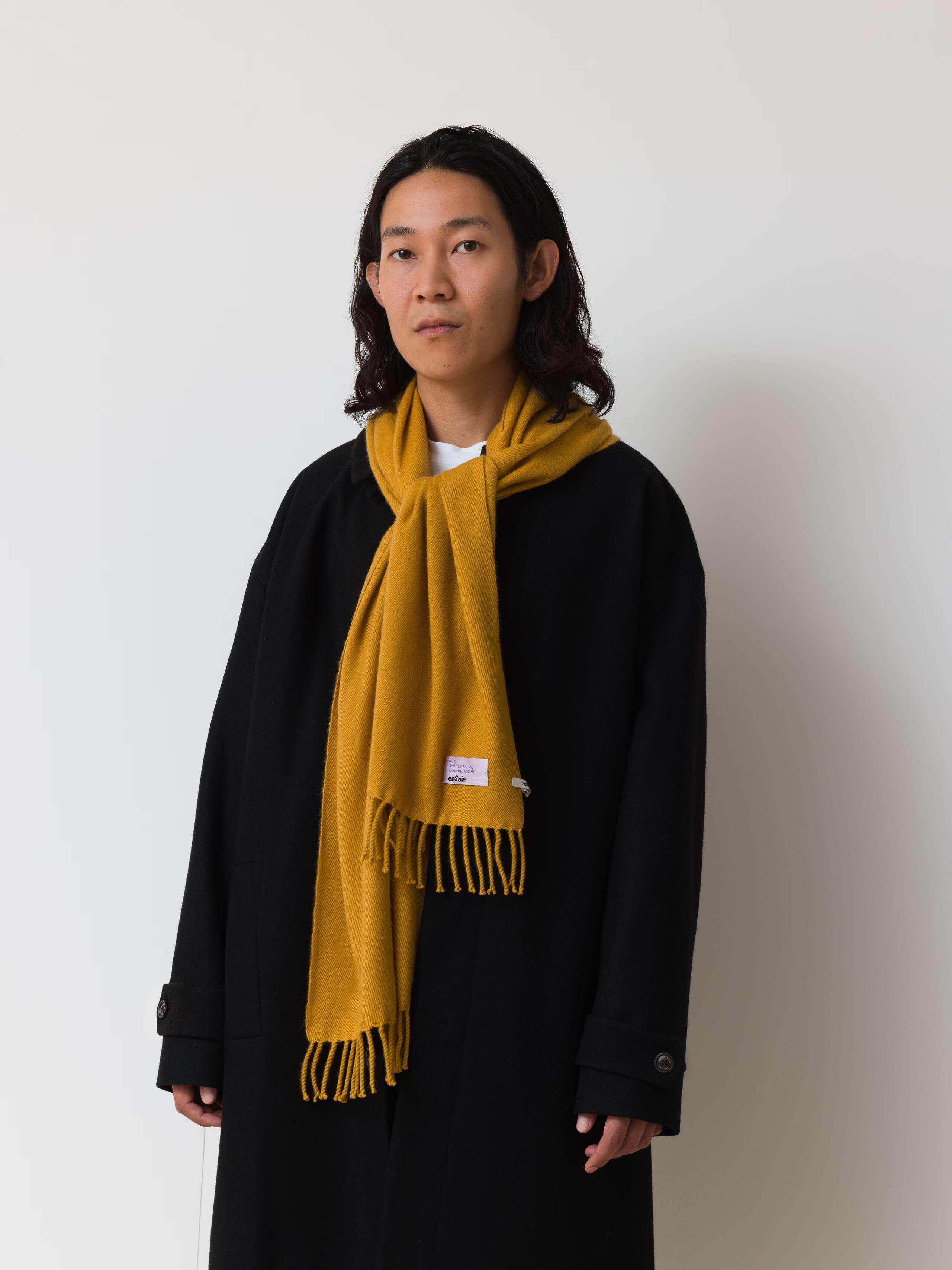 Picture of a male model wearing a yellow cashmere scarf